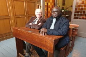 Bros. Augustine and Frans Wils are sitting on the old pupil chair
