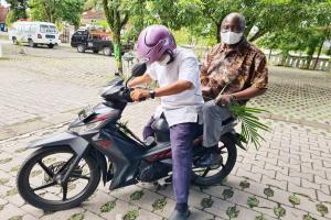 Bros. Augustine and Johanes are riding motorbike