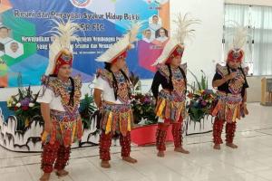 Candidates in formation perform traditional dance